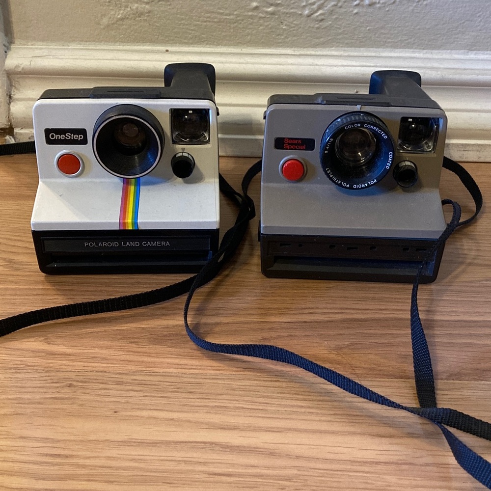 Polaroid Instant Land Cameras in White and Gray with Rainbow Accent